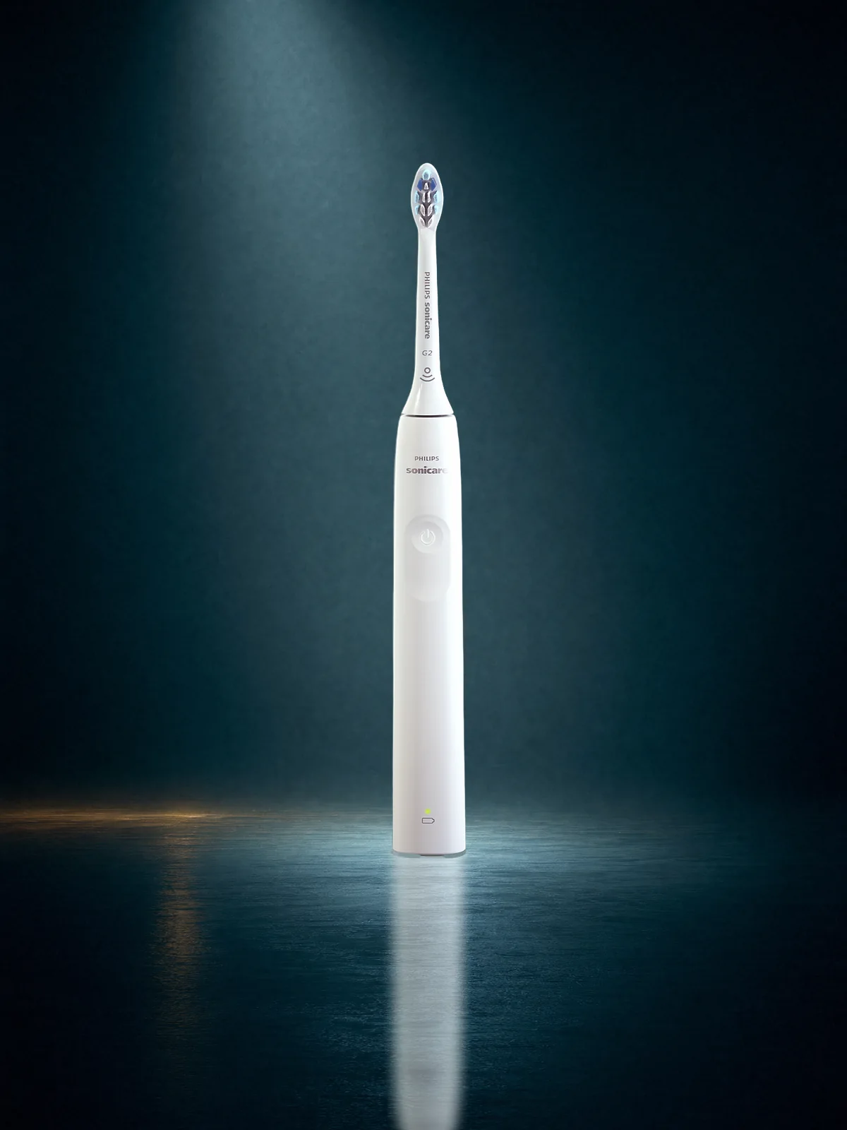 A white Philips Sonicare power toothbrush with its G2 brush head fitted, standing in a shaft of moonlight on dark water